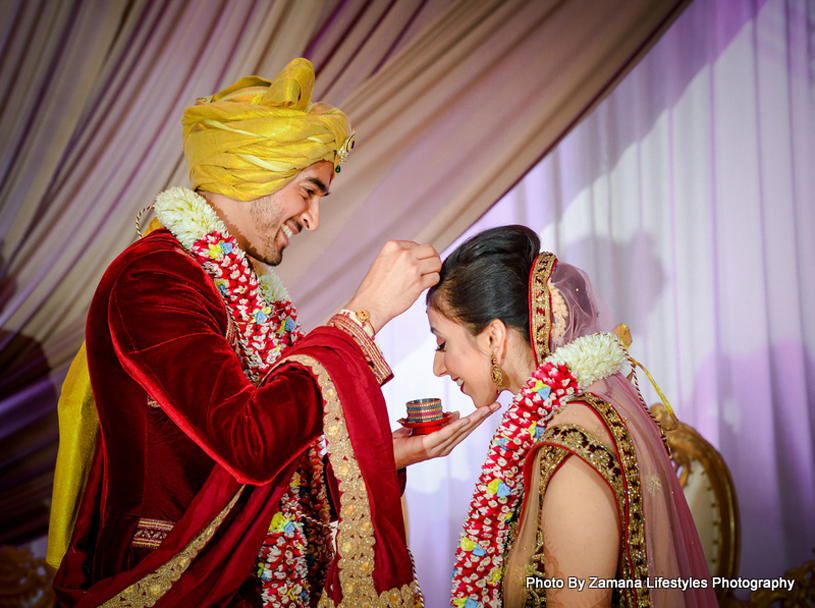 Indian Groom applying Sindoor to Bride